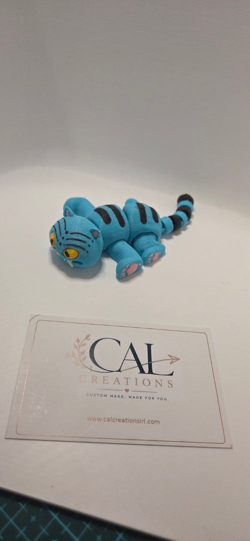 Side view showing articulated blue cat body, black stripes and tail