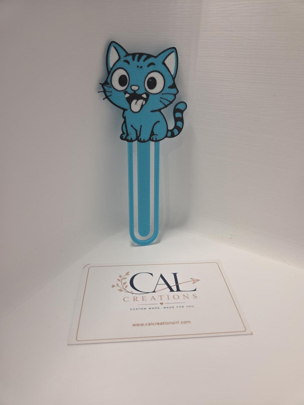 Blue cartoon cat bookmark, front view with CalCreations branding