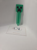 Green and black pixel-style character bookmark, finished product photo