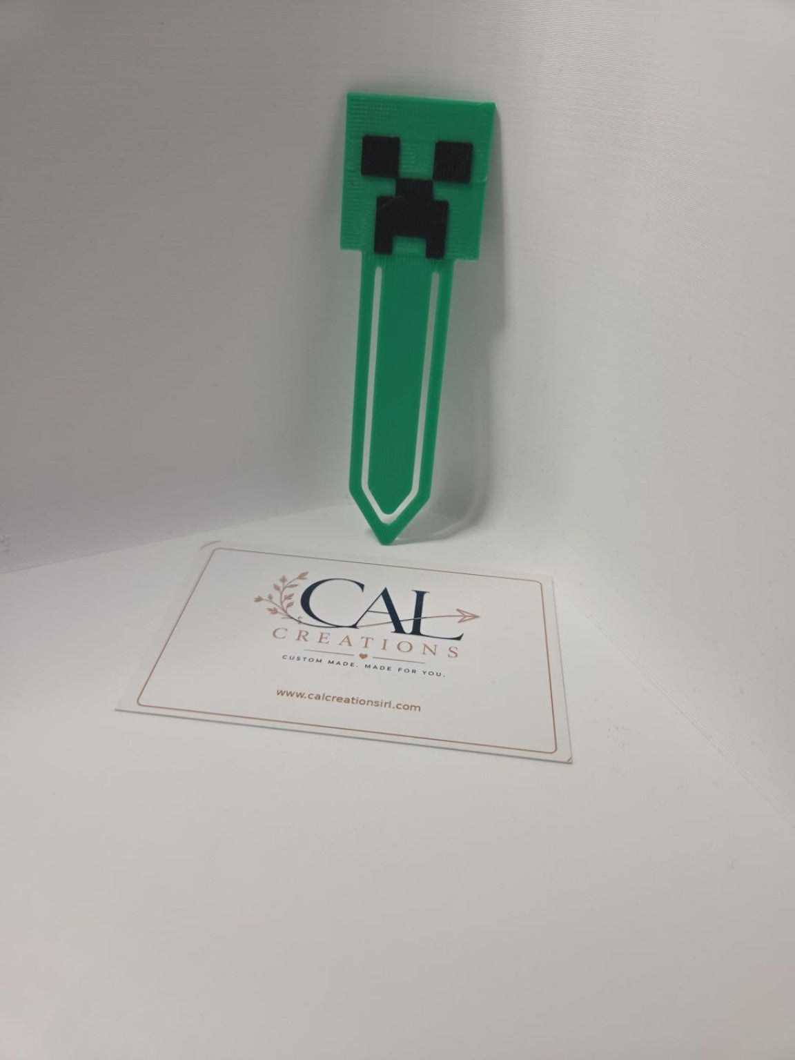 Green and black pixel-style character bookmark, finished product photo