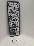 Front view of black and white Just One More Chapter bookmark with burgundy tassel