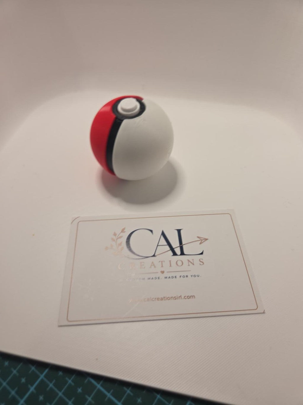 Angled view of red white and black Poké Ball clicker