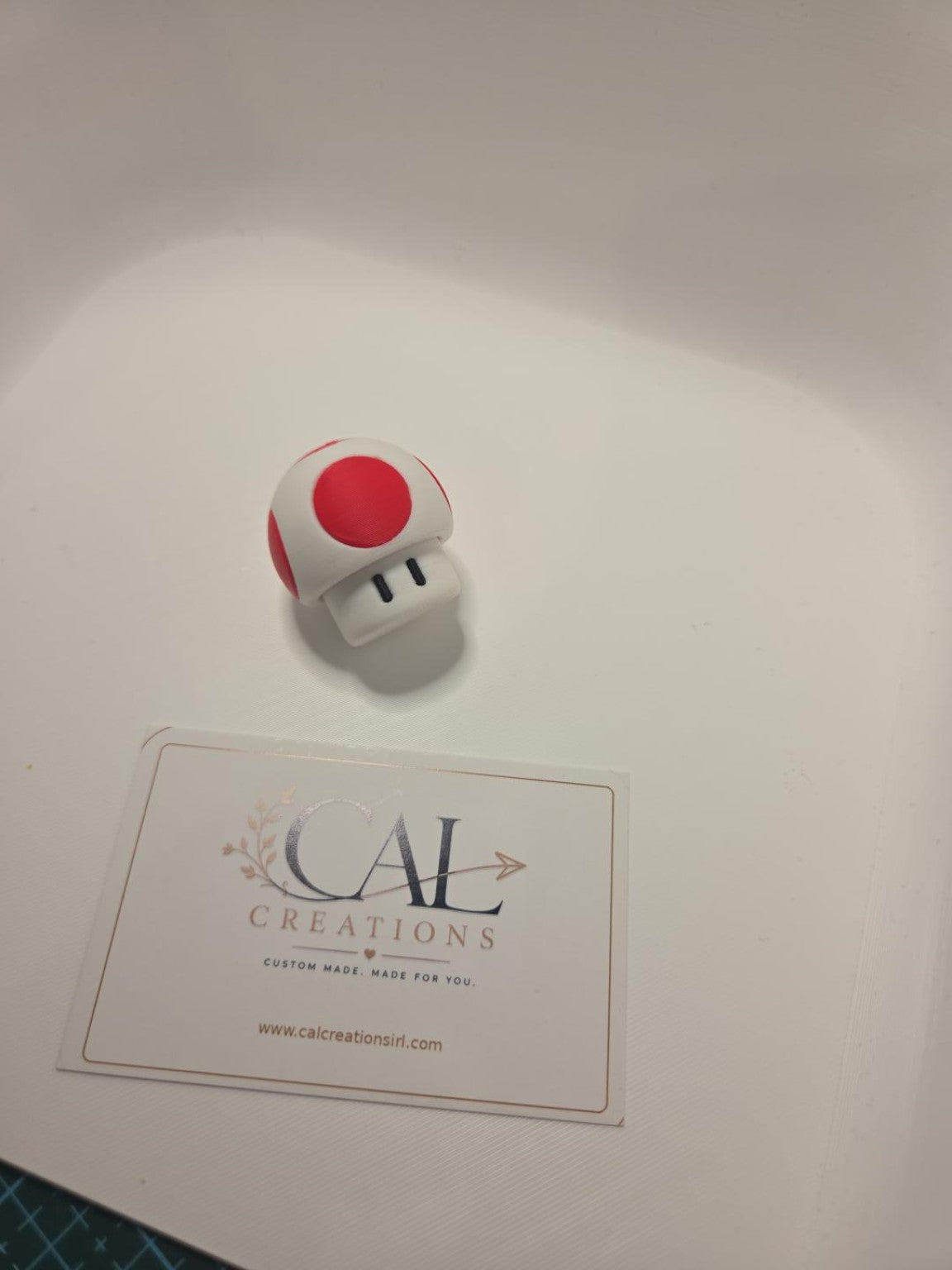 Angled view of finished red and white mushroom clicker