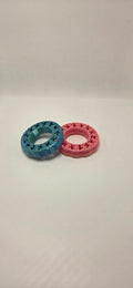 Two 3D printed gear ring fidgets in Pink Gradient and Blue/Green Metallic Silk