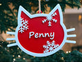 Personalised red and white cat Christmas decoration with the name Penny