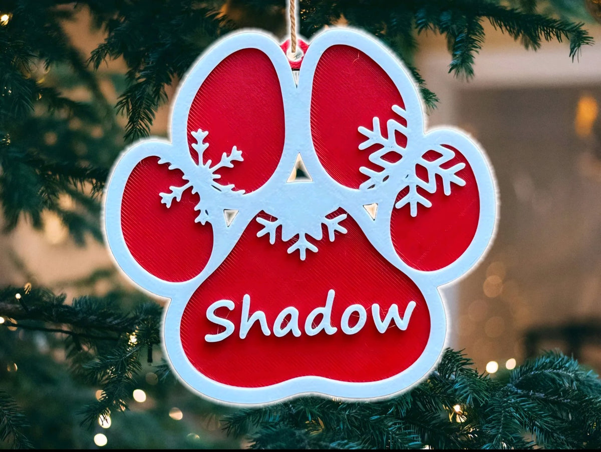 Personalised red and white dog paw Christmas decoration with the name Shadow