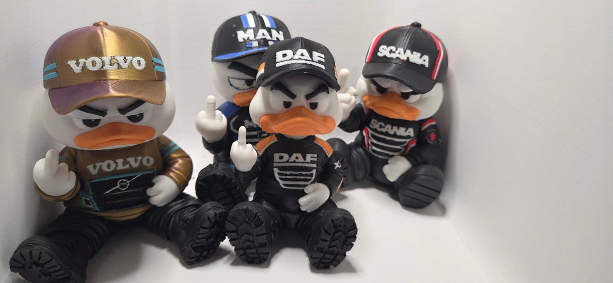 Four 15 cm 3D-printed trucker ducks in Volvo, DAF, MAN and Scania designs